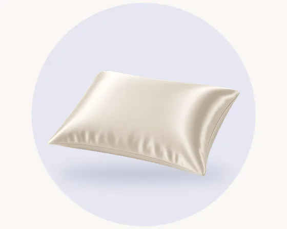 Product illustration: a smooth, softly sheened silk pillowcase, on a pale pastel circle